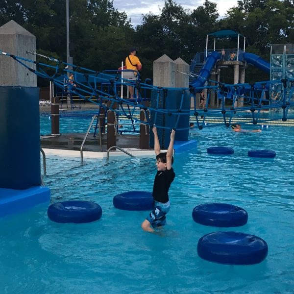 Little one doing rope course at Memorial Park Family Aquatic Center.