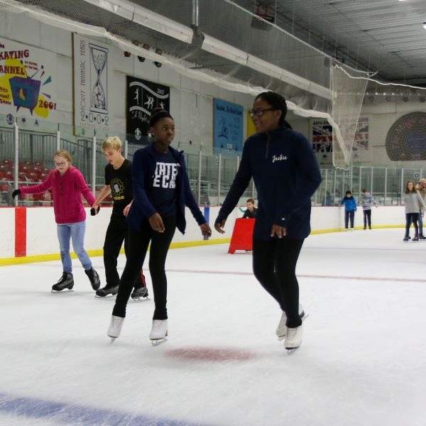 Two girls skating at Washington Park Ice Arena