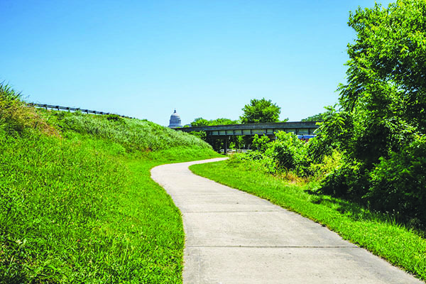 JC Parks Greenway Trail with Jefferson City Capitol building in the background.